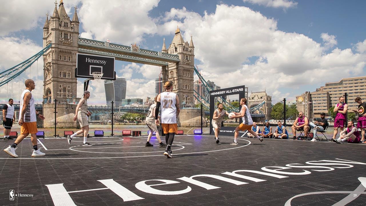 Wide view of the floating basketball court beside Tower Bridge.