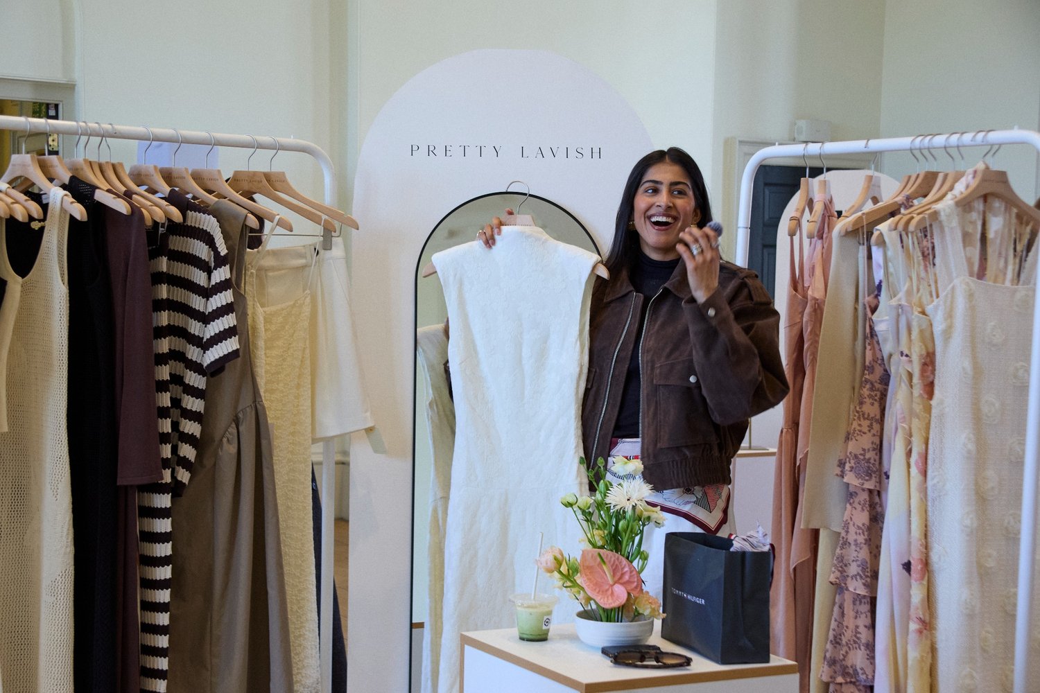 Guest holding a dress at the Pretty Lavish rail during LTK Studio.